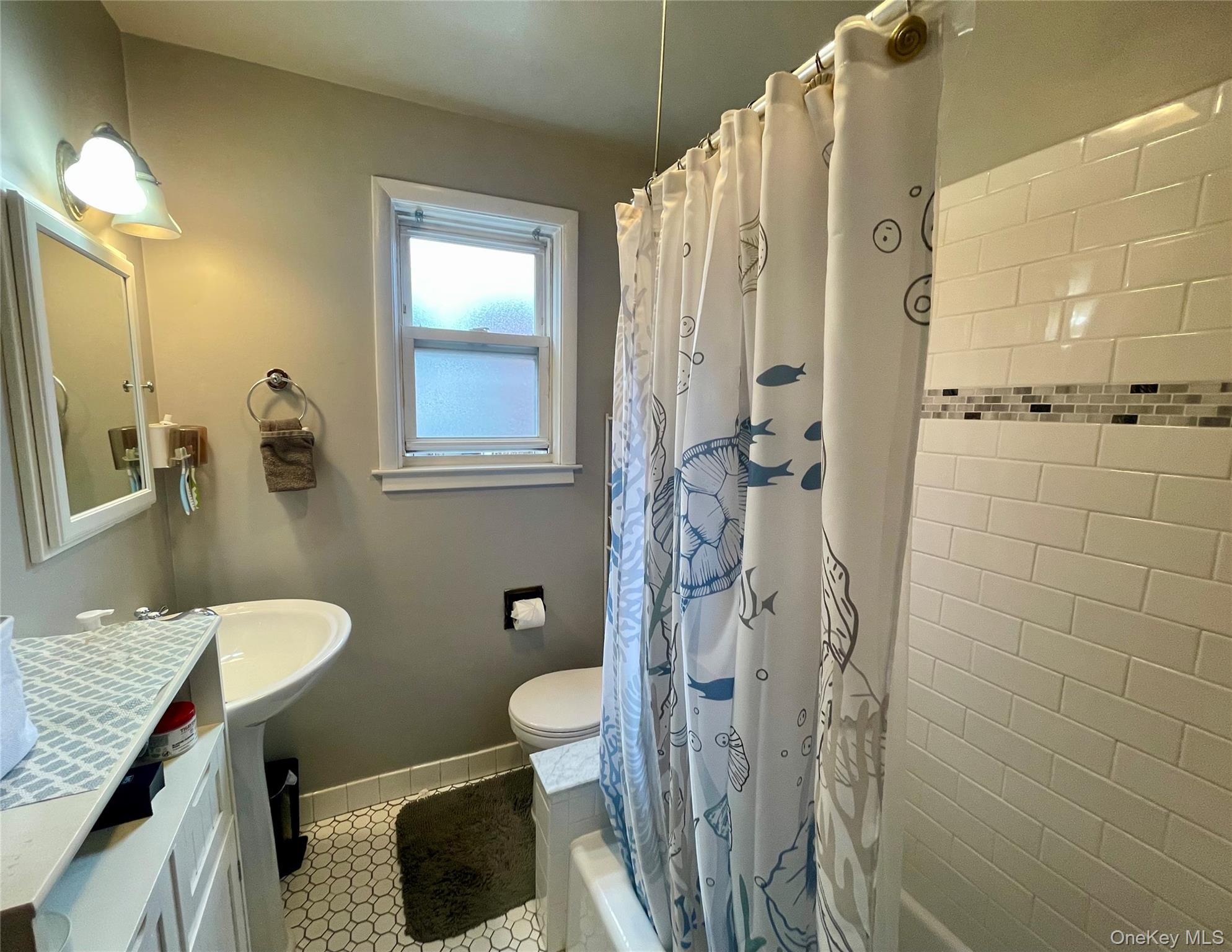 372 East 235th Street Bronx, NY 10470 - Photo 11 of 36 a bathroom with a granite countertop sink toilet and shower