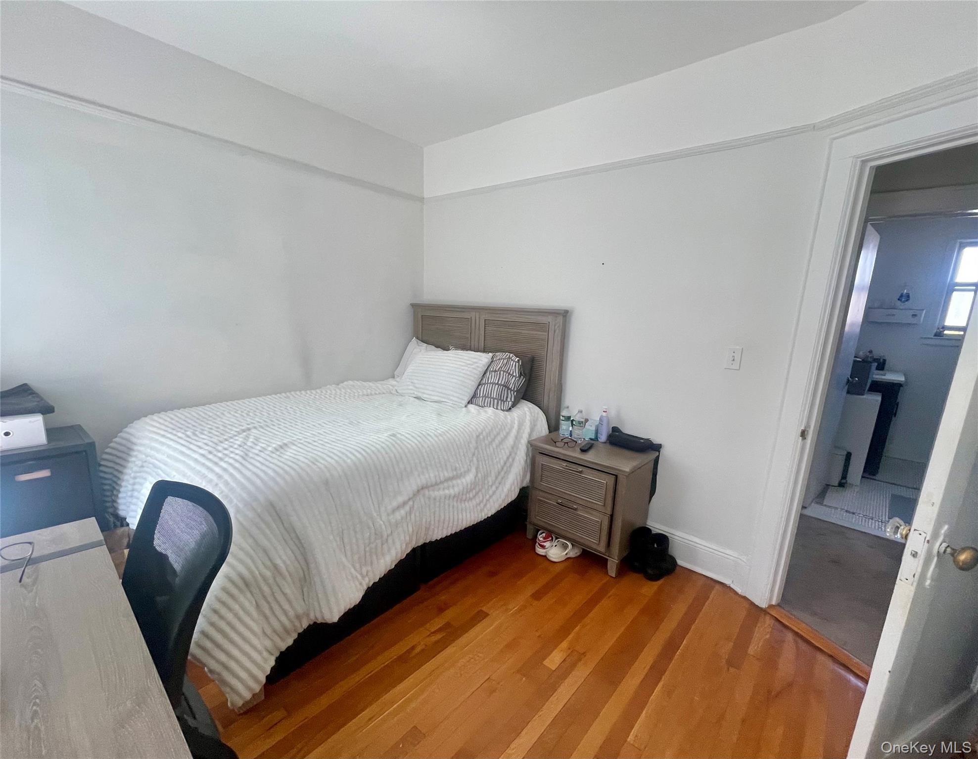 372 East 235th Street Bronx, NY 10470 - Photo 20 of 36 a bedroom with a bed and a chair
