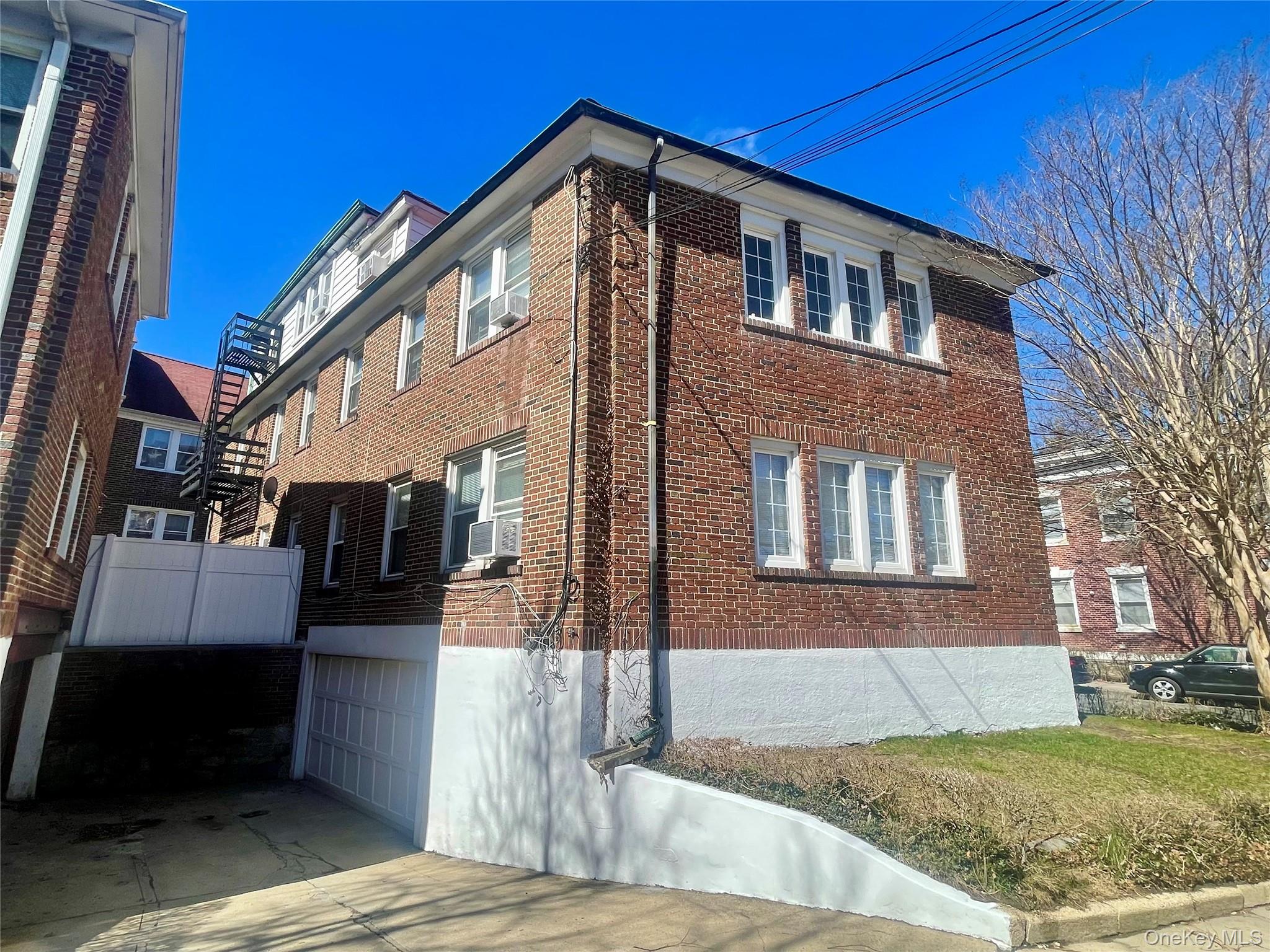 372 East 235th Street Bronx, NY 10470 - Photo 30 of 36 a front view of a house with a yard
