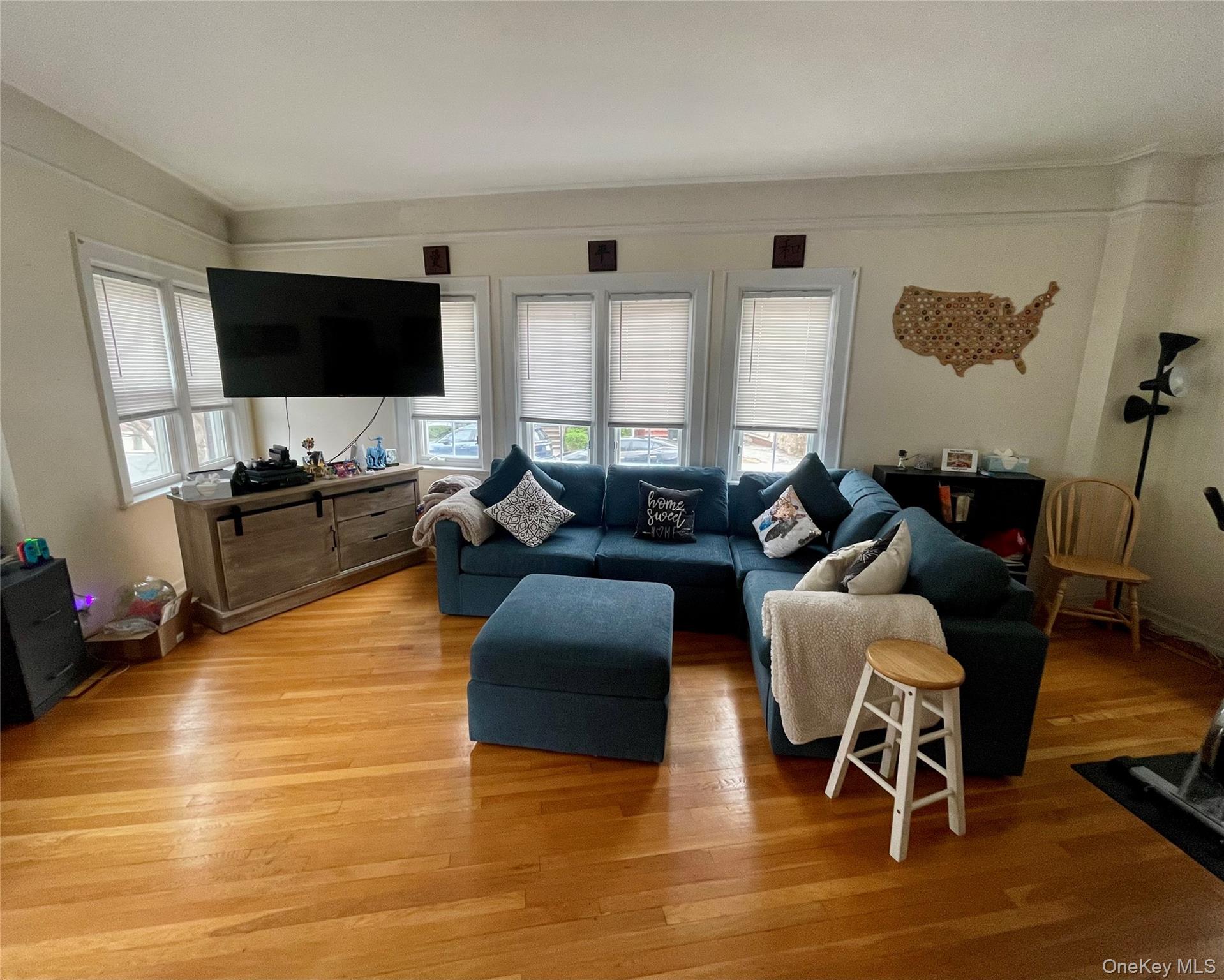 372 East 235th Street Bronx, NY 10470 - Photo 7 of 36 a living room with furniture flat screen tv and wooden floor