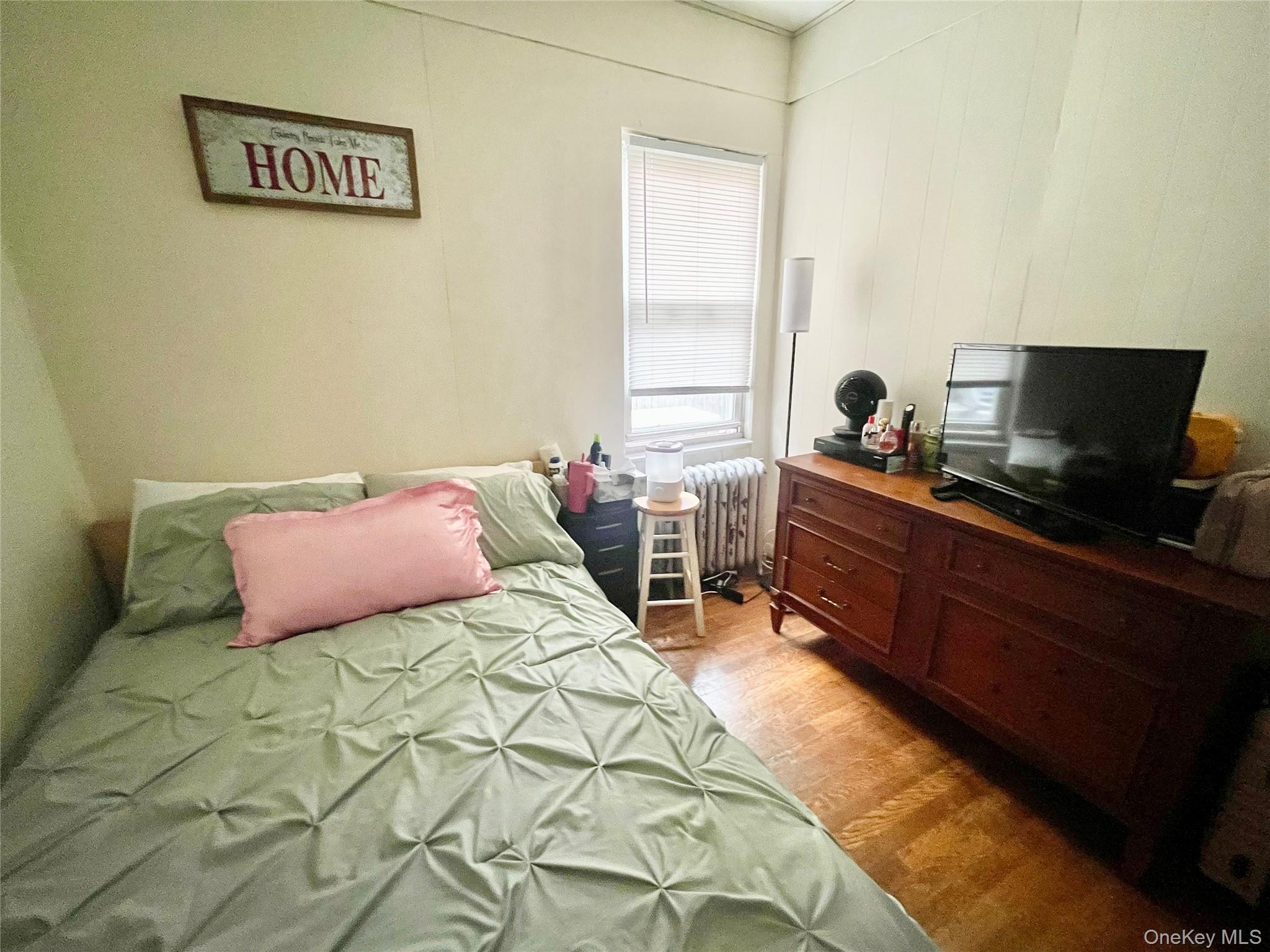 372 East 235th Street Bronx, NY 10470 - Photo 10 of 36 a bedroom with a bed and a window