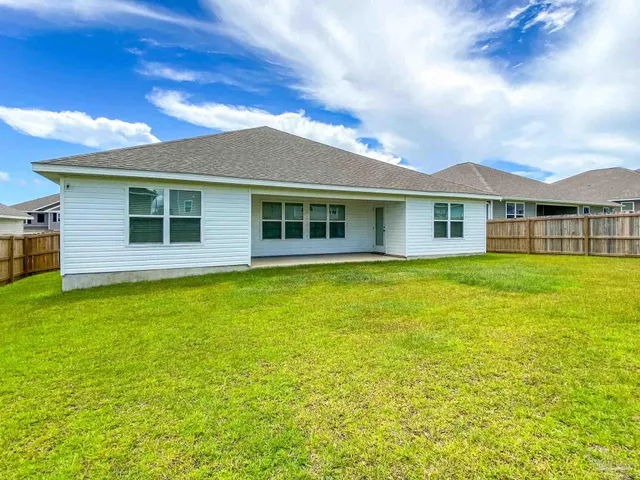 a view of a house with a backyard