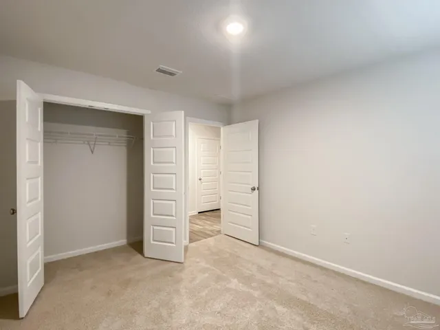 an empty room with a closet and closet