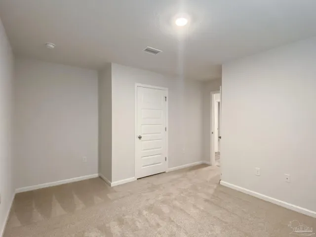 an empty room with closet area