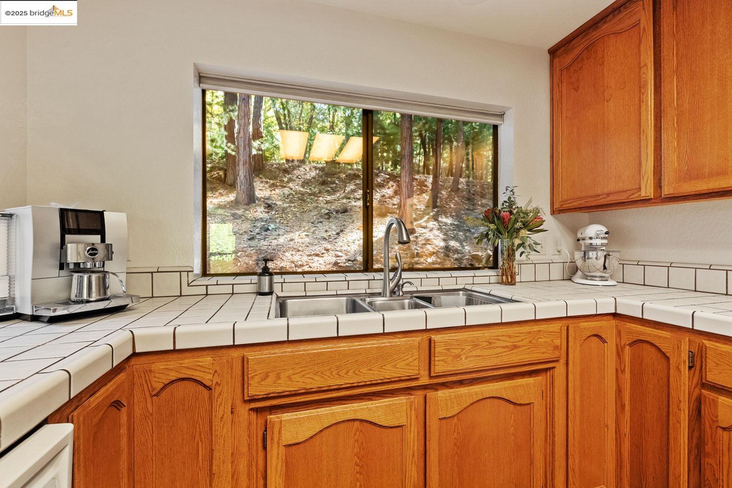 24181 Awahanee Road Sonora, CA 95370 - Photo 26 of 48 a kitchen with stainless steel appliances sink large window and cabinets