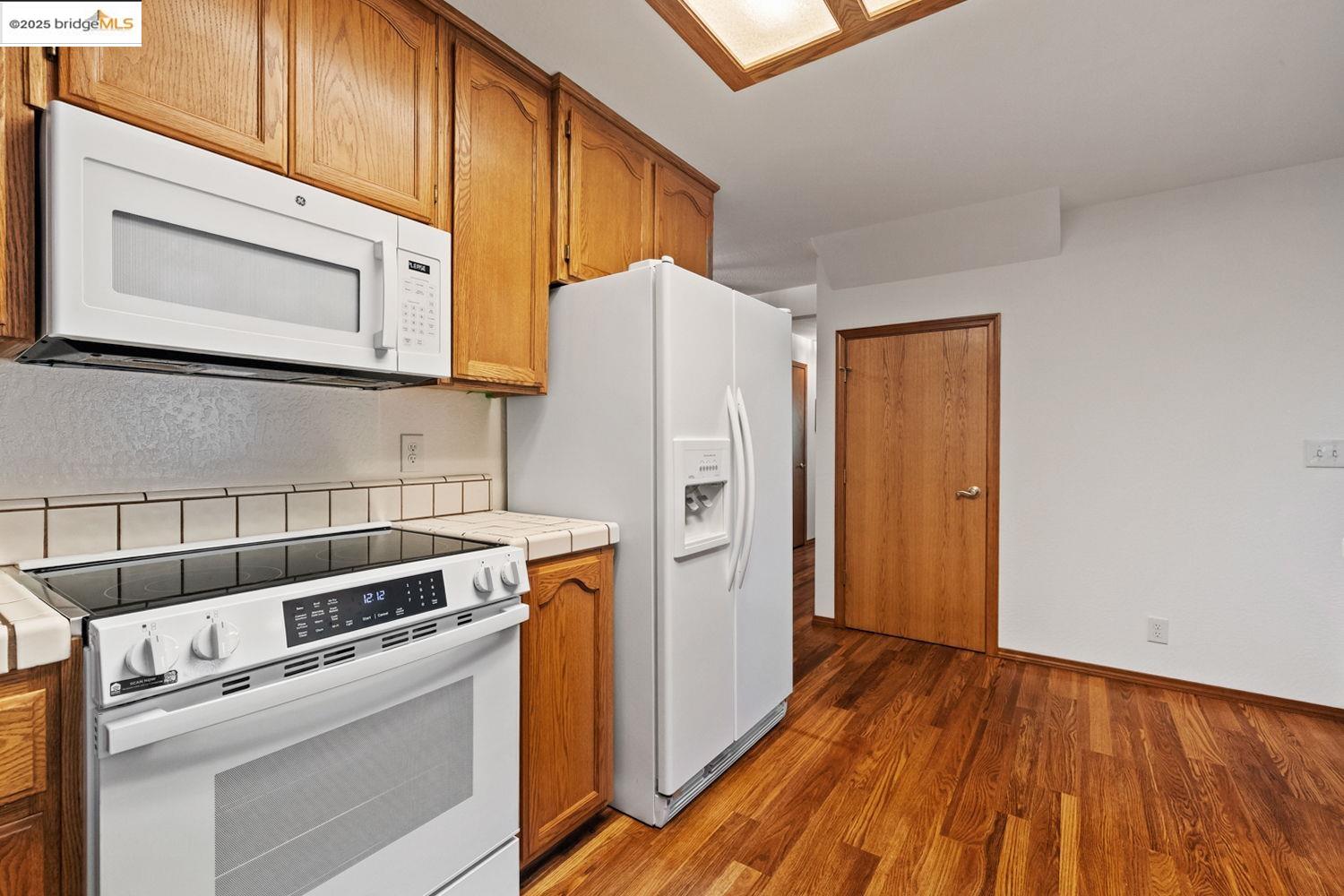 24181 Awahanee Road Sonora, CA 95370 - Photo 27 of 48 a kitchen with a white cabinets and white appliances