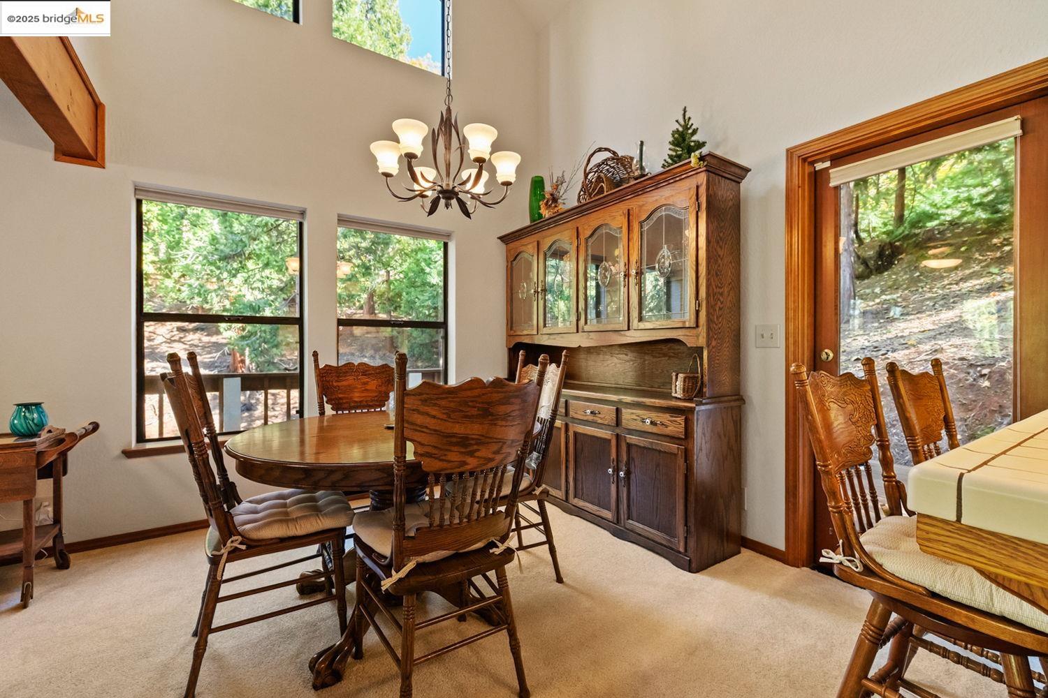 24181 Awahanee Road Sonora, CA 95370 - Photo 29 of 48 a dining room with furniture a chandelier and wooden floor