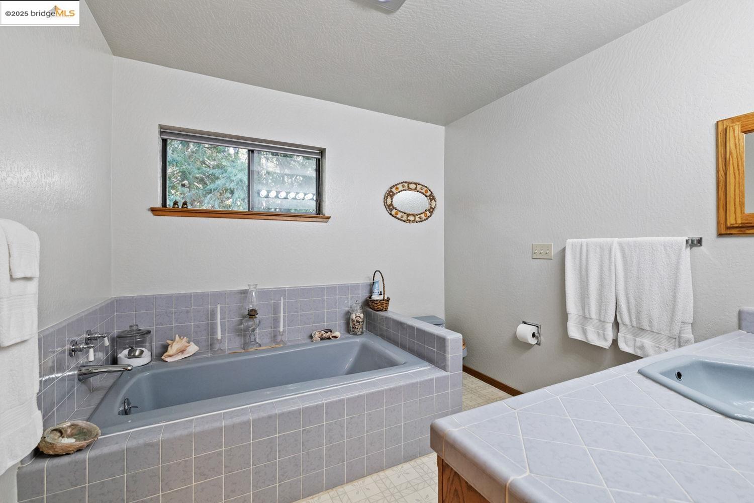 24181 Awahanee Road Sonora, CA 95370 - Photo 32 of 48 a bathroom with a tub sink and mirror