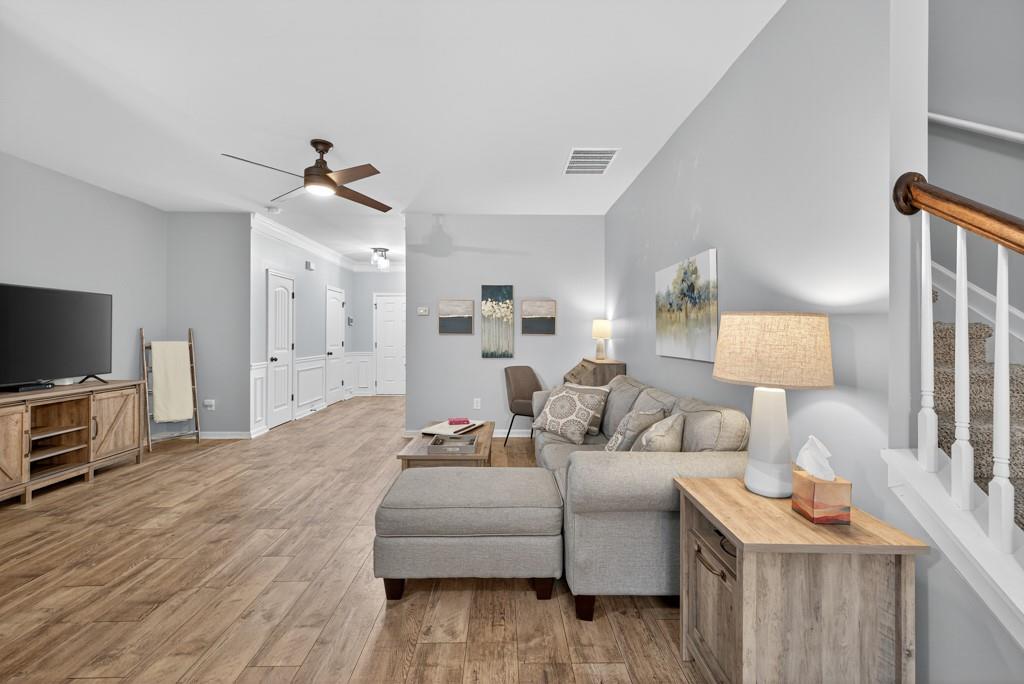 256 Valley Crossing Canton, GA 30114 - Photo 11 of 41 a living room with furniture a flat screen tv and a wooden floor