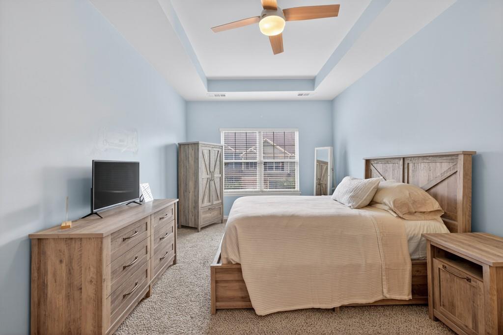 256 Valley Crossing Canton, GA 30114 - Photo 22 of 41 a bedroom with a bed and a flat tv screen on dresser