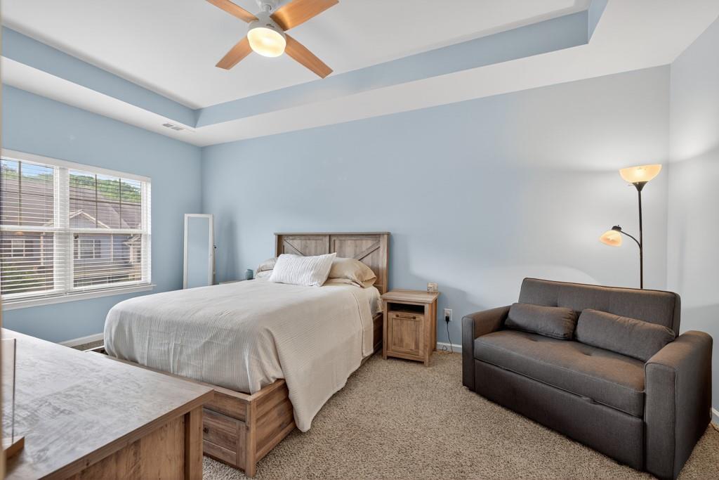 256 Valley Crossing Canton, GA 30114 - Photo 24 of 41 a bedroom with a bed couch and window