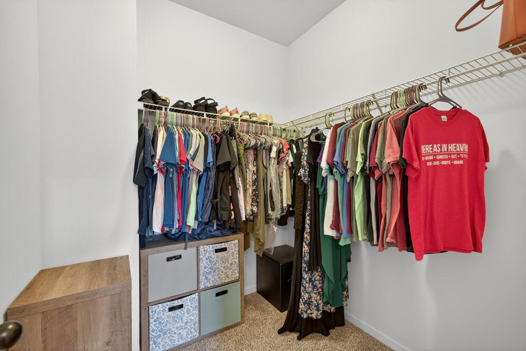 256 Valley Crossing Canton, GA 30114 - Photo 28 of 41 a view of walk in closet with clothes