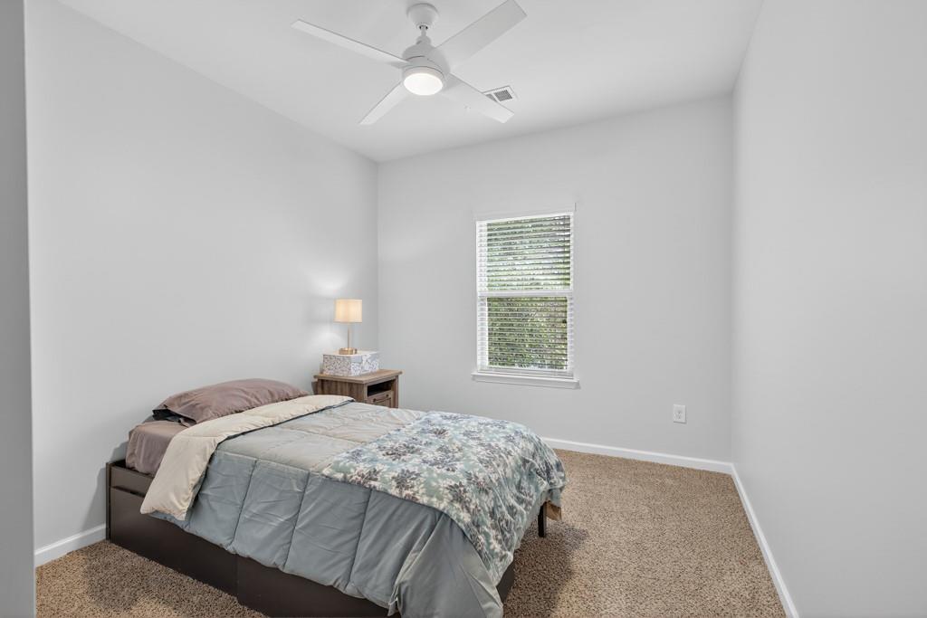 256 Valley Crossing Canton, GA 30114 - Photo 31 of 41 a bedroom with a bed and a window