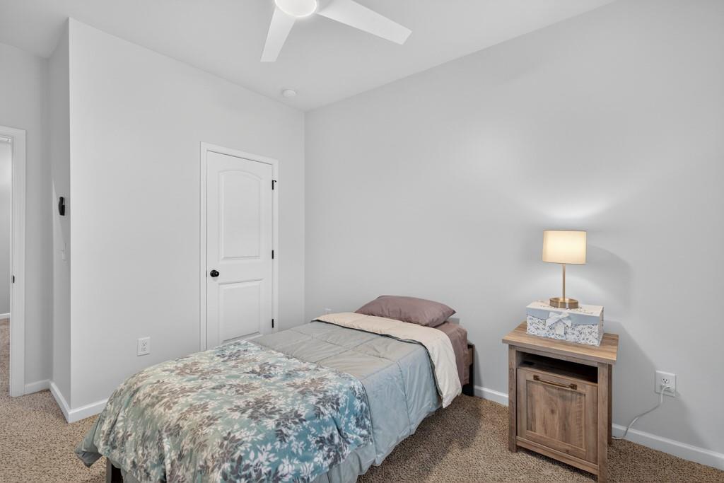 256 Valley Crossing Canton, GA 30114 - Photo 32 of 41 a bedroom with a bed and a lamp