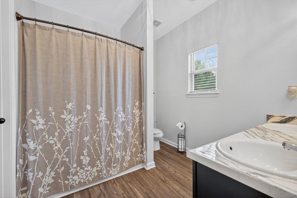 256 Valley Crossing Canton, GA 30114 - Photo 5 of 41 a view of a bedroom with wooden floor and a sink