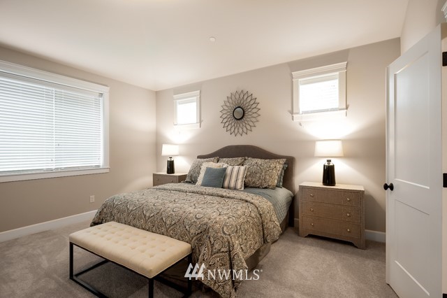 3 233rd Place Southeast Bothell, WA 98021 - Photo 13 of 16 a bedroom with a bed and a dresser next to a window