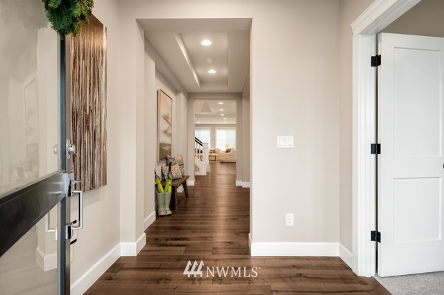 3 233rd Place Southeast Bothell, WA 98021 - Photo 4 of 16 a view of a hallway with wooden floor and staircase