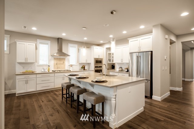 3 233rd Place Southeast Bothell, WA 98021 - Photo 8 of 16 a kitchen with a sink a center island stainless steel appliances and cabinets