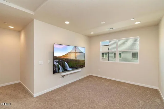 an empty room with windows and mirror