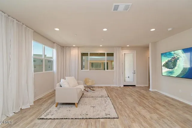 a spacious bedroom with a large bed and a window