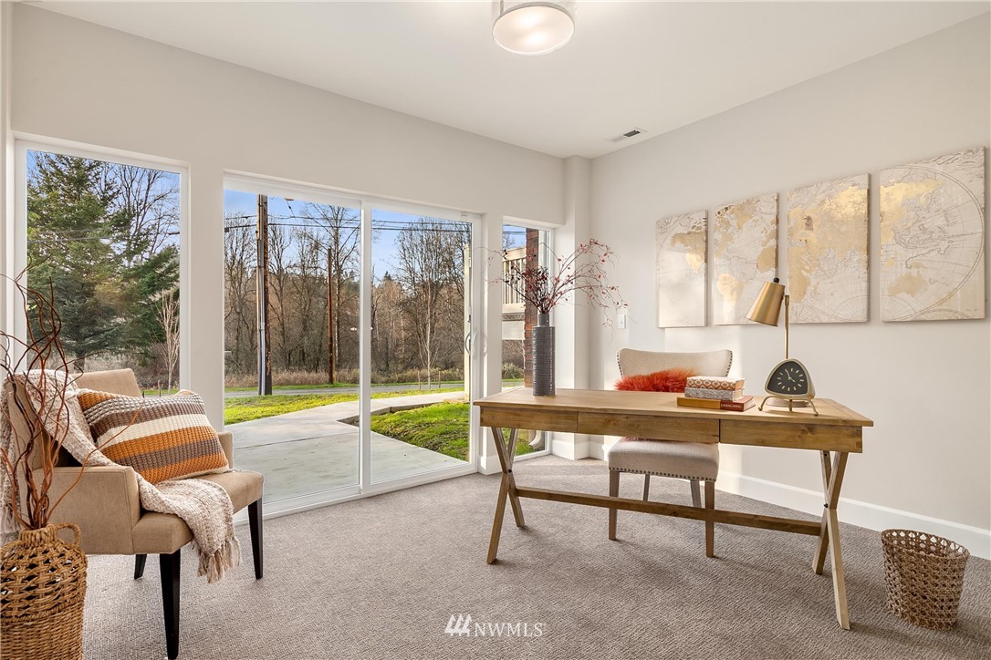 17522 West Riverside Drive Bothell, WA 98011 - Photo 22 of 28 a living room with furniture and a large window