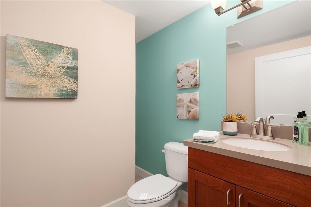 17522 West Riverside Drive Bothell, WA 98011 - Photo 23 of 28 a bathroom with a toilet a sink and a mirror