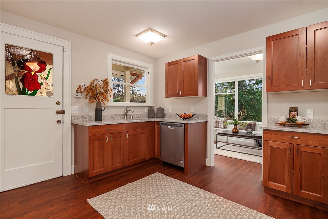 17522 West Riverside Drive Bothell, WA 98011 - Photo 10 of 28 a kitchen with sink cabinets and wooden floor