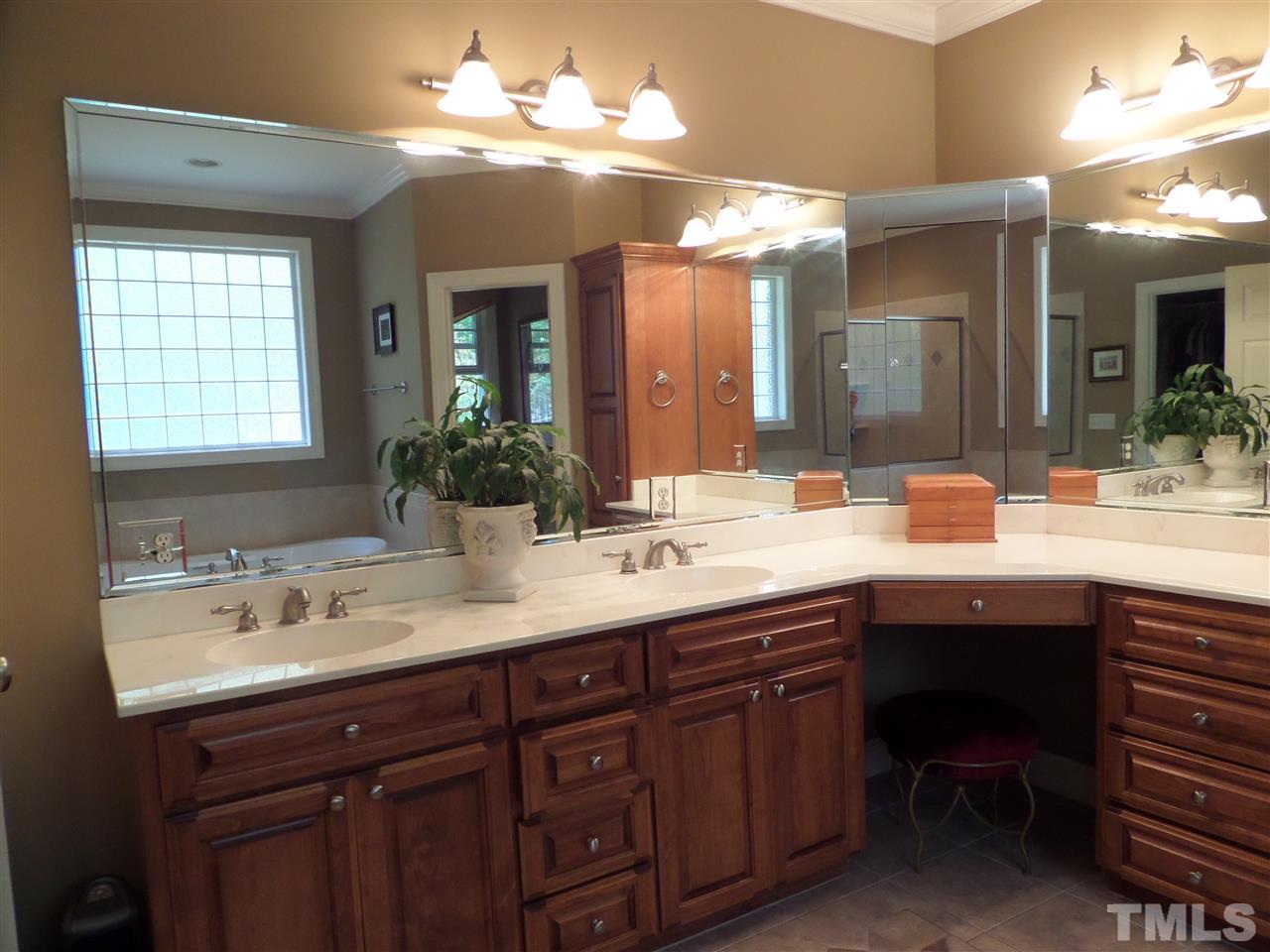 5236 Levering Mill Road Apex, NC 27539 - Photo 14 of 25 Spa like master bath with ceramic tile floors and shower walls, upgraded cabinets/counters with dressing table, separate water closet for privacy