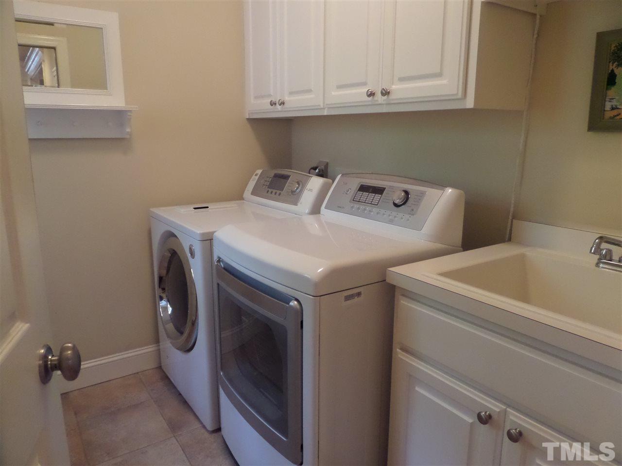 5236 Levering Mill Road Apex, NC 27539 - Photo 15 of 25 Laundry has utility sink and cabinets to beat your laundry day blues