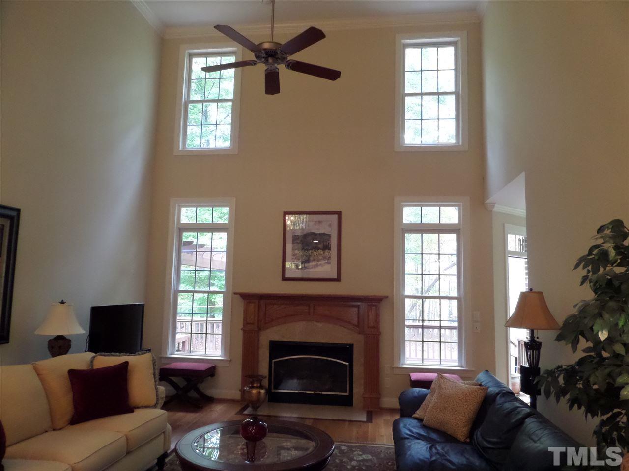 5236 Levering Mill Road Apex, NC 27539 - Photo 6 of 25 Beautiful Family Room with two story ceiling and wall of windows, Gas FP for those chilly nights too.