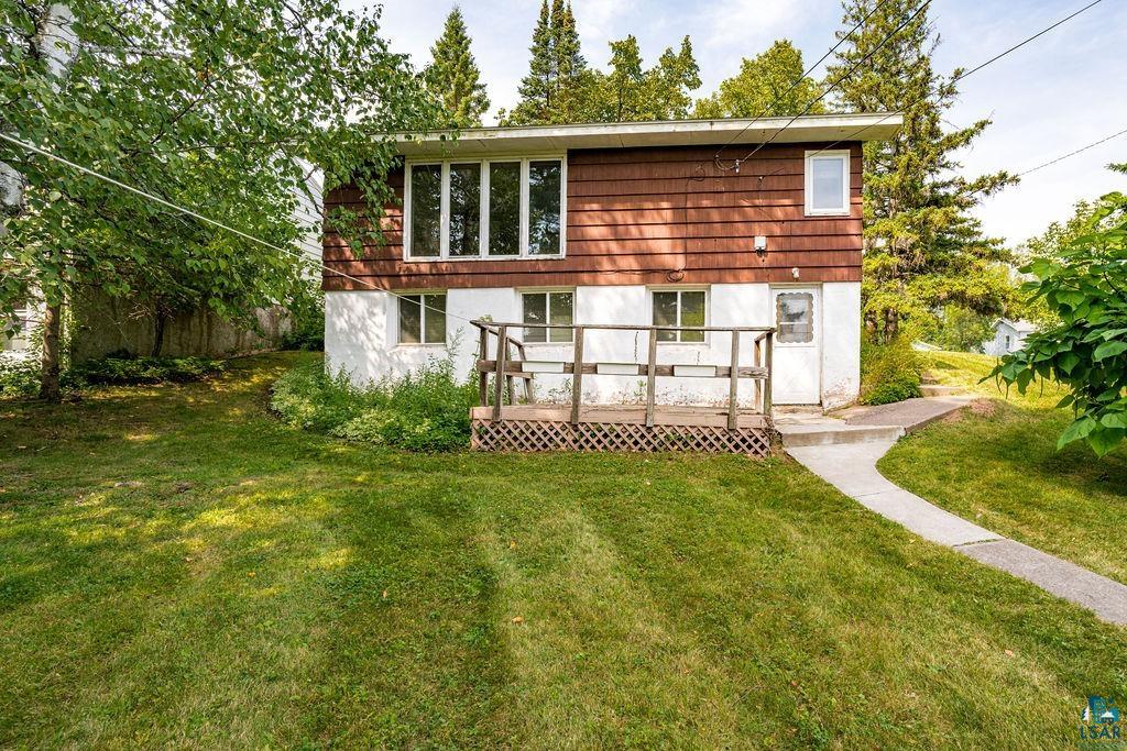 4930 Oneida Street Duluth, MN 55804 - Photo 18 of 19 Back of house featuring a deck and a lawn