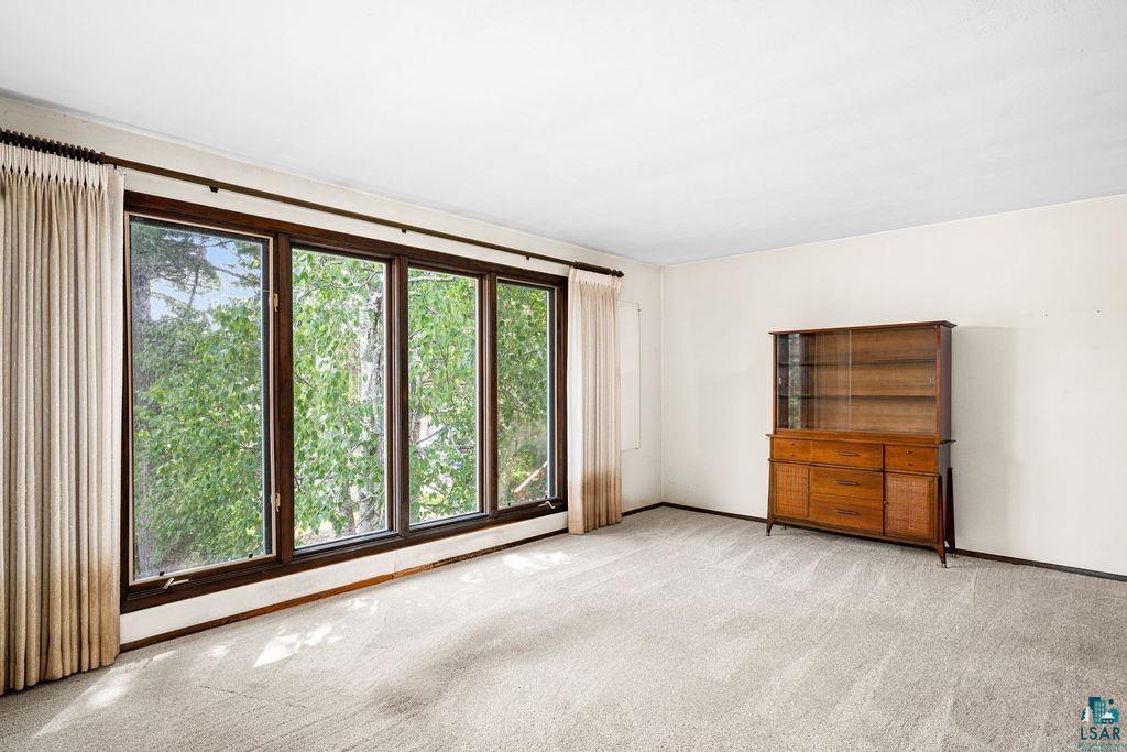 4930 Oneida Street Duluth, MN 55804 - Photo 3 of 19 Empty room with light carpet and plenty of natural light
