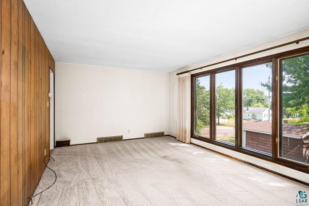 4930 Oneida Street Duluth, MN 55804 - Photo 4 of 19 Carpeted spare room featuring wooden walls