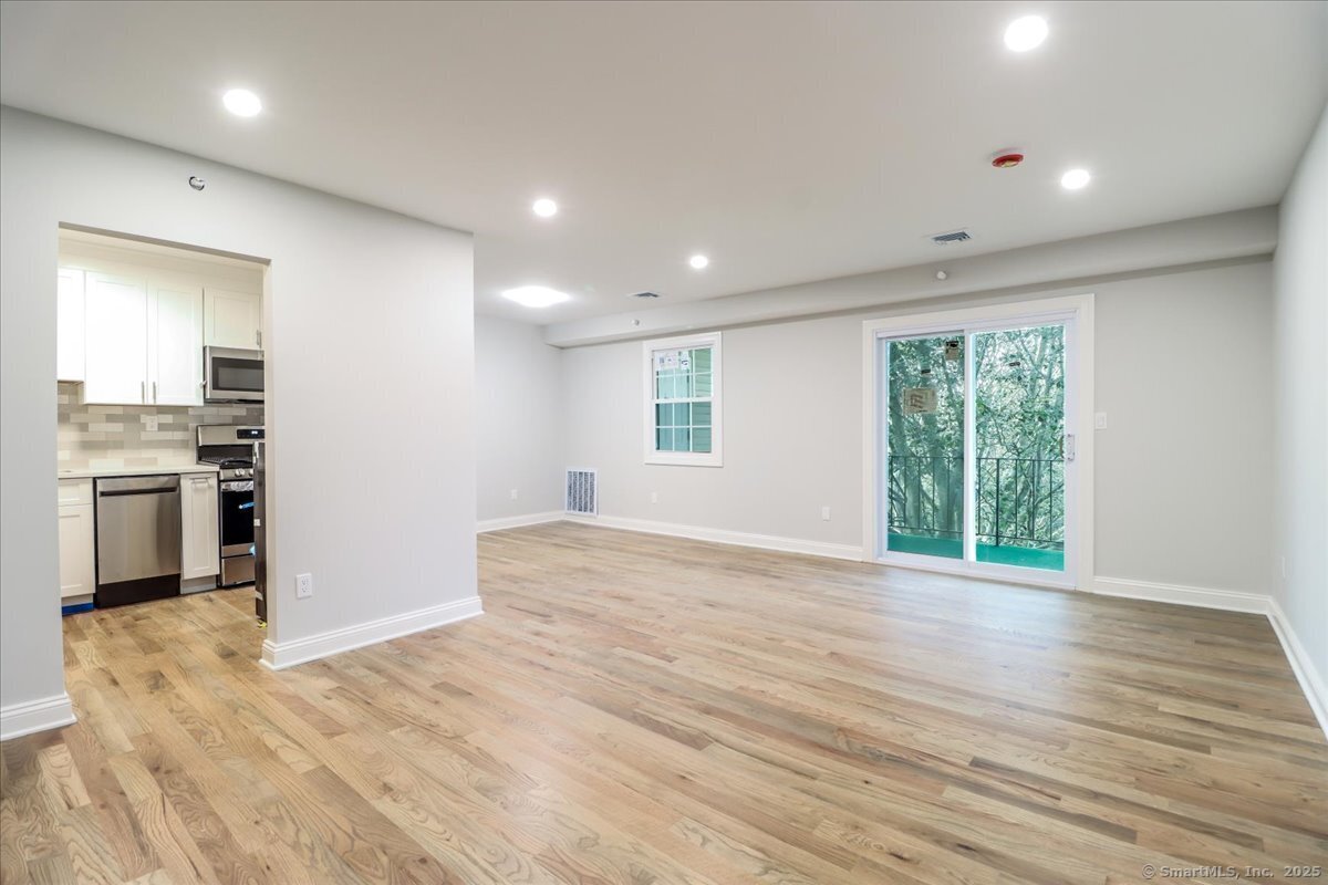 50 Greenhouse Road, Unit 42C Bridgeport, CT 06606 - Photo 2 of 26 Sun filled entry way to living and dining area