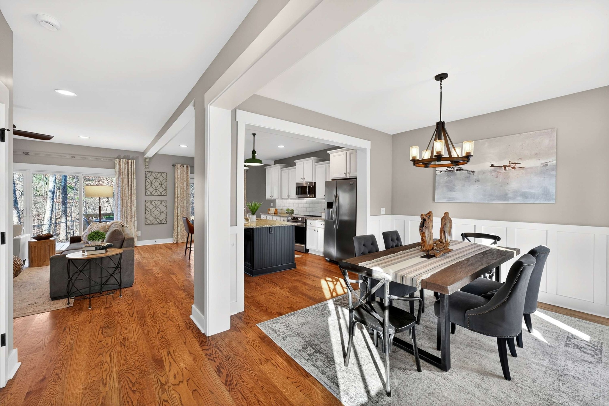 4852 Ash Hill Road Spring Hill, TN 37174 - Photo 11 of 45 a view of a dining room and livingroom with furniture wooden floor a chandelier