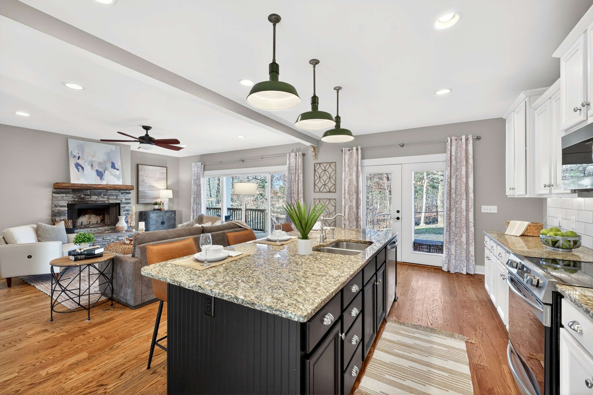4852 Ash Hill Road Spring Hill, TN 37174 - Photo 13 of 45 a kitchen with granite countertop kitchen island stainless steel appliances a stove center island a table and chairs