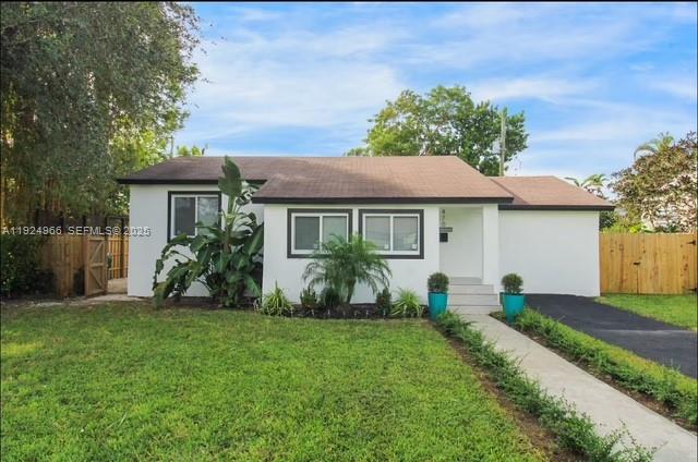 470 Northeast 110th Street Miami, FL 33161 - Photo 1 of 20 a front view of a house with a yard and porch