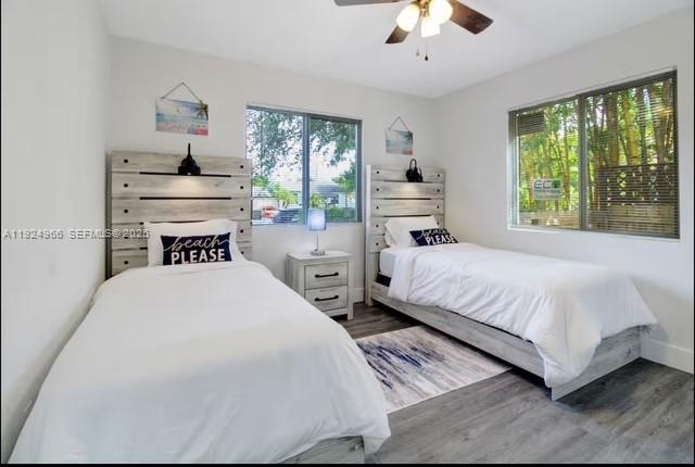 470 Northeast 110th Street Miami, FL 33161 - Photo 14 of 20 a bedroom with a large bed and a chandelier