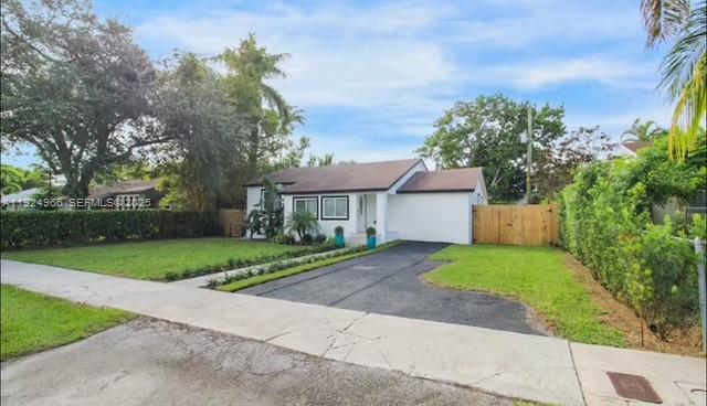 470 Northeast 110th Street Miami, FL 33161 - Photo 2 of 20 front view of a house with a yard and a street