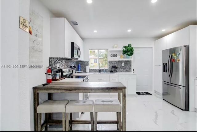 470 Northeast 110th Street Miami, FL 33161 - Photo 7 of 20 a kitchen with stainless steel appliances granite countertop a stove a sink and a refrigerator