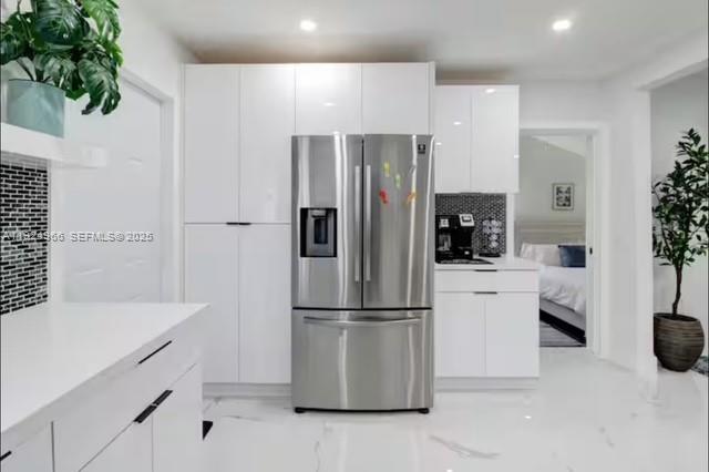 470 Northeast 110th Street Miami, FL 33161 - Photo 8 of 20 a kitchen with a refrigerator and white cabinets
