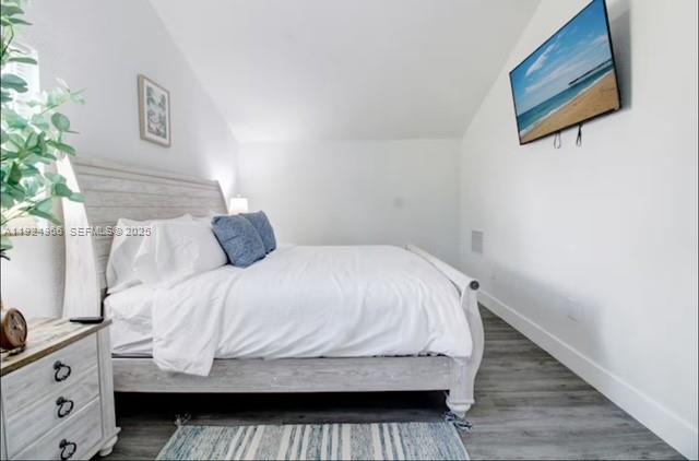 470 Northeast 110th Street Miami, FL 33161 - Photo 9 of 20 a bedroom with bed and wooden floor