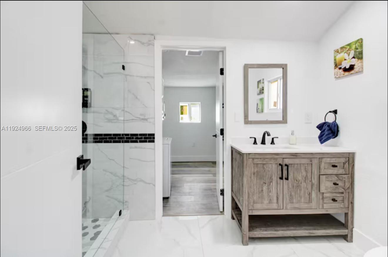 470 Northeast 110th Street Miami, FL 33161 - Photo 10 of 20 a bathroom with a sink a mirror and shower