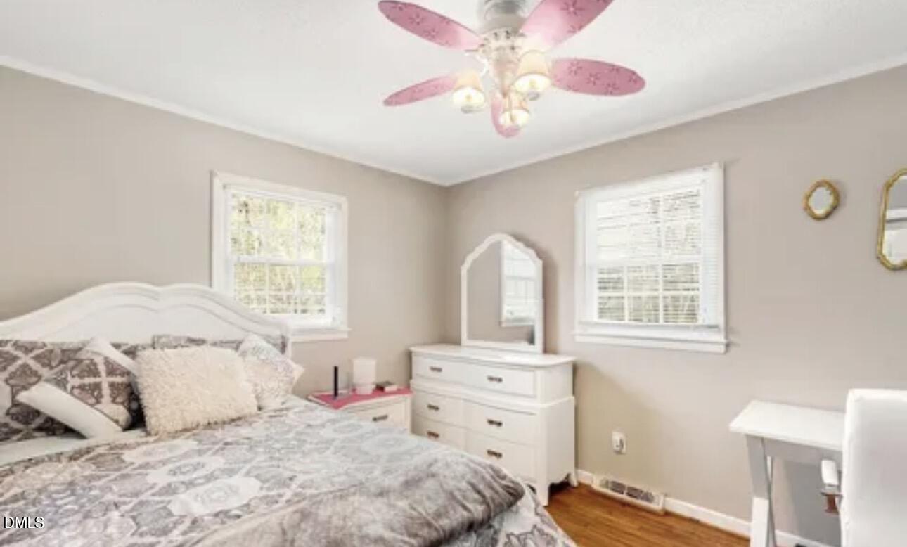 810 Milton Road Durham, NC 27712 - Photo 13 of 21 a bedroom with a bed and a chandelier