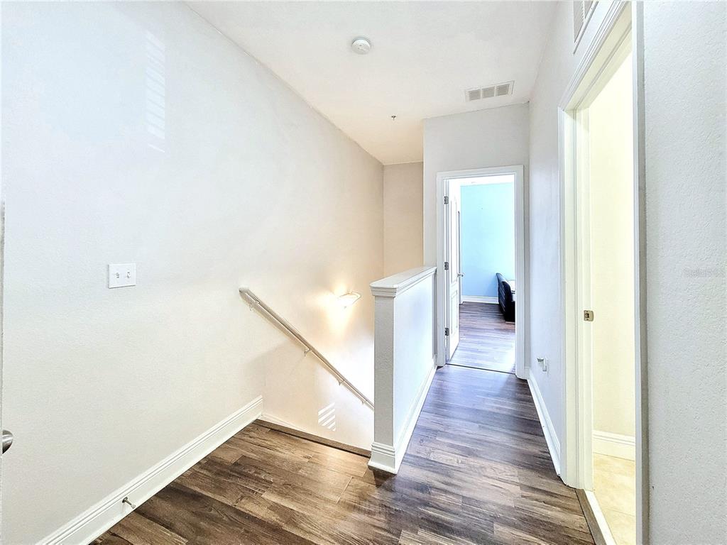 2946 Southwest 35th Place, Unit 44 Gainesville, FL 32608 - Photo 16 of 25 a view of a hallway with wooden floor