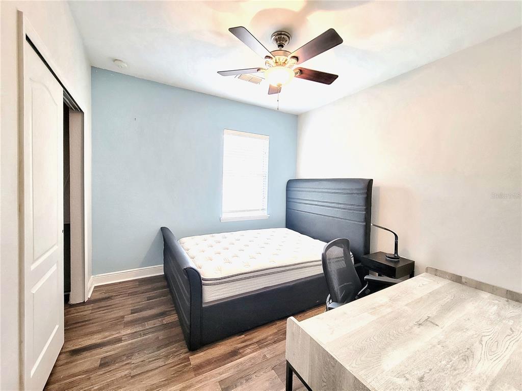 2946 Southwest 35th Place, Unit 44 Gainesville, FL 32608 - Photo 17 of 25 a bedroom with two beds and a chandelier