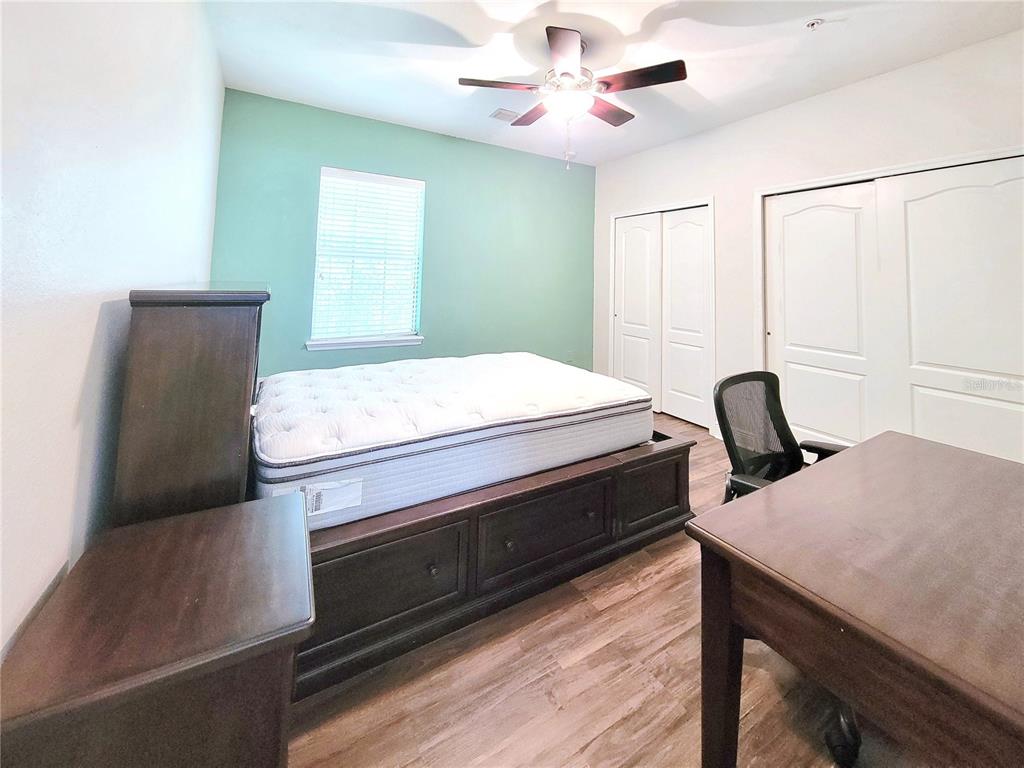 2946 Southwest 35th Place, Unit 44 Gainesville, FL 32608 - Photo 24 of 25 a room with a bed and a dresser