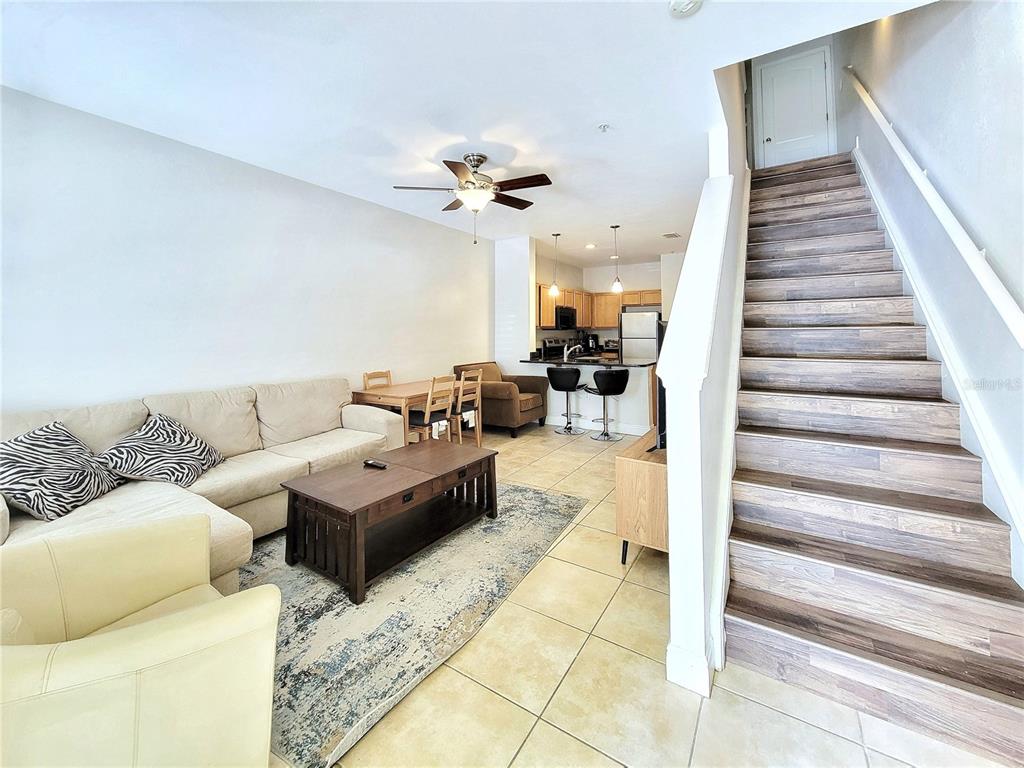 2946 Southwest 35th Place, Unit 44 Gainesville, FL 32608 - Photo 4 of 25 a living room with furniture and stairs