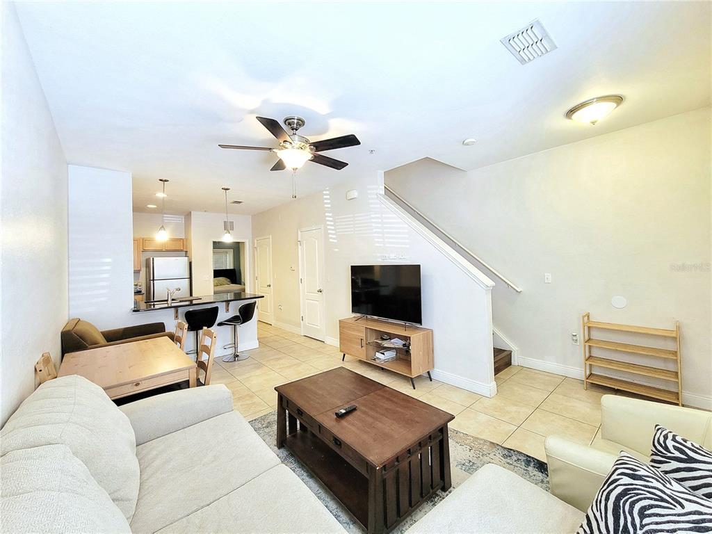 2946 Southwest 35th Place, Unit 44 Gainesville, FL 32608 - Photo 6 of 25 a living room with furniture and a flat screen tv