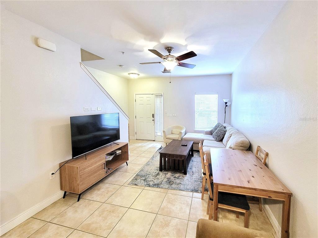 2946 Southwest 35th Place, Unit 44 Gainesville, FL 32608 - Photo 8 of 25 a living room with furniture and a flat screen tv